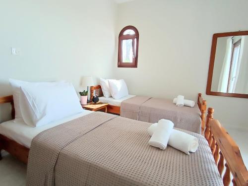 a bedroom with two beds and a mirror at Holiday home with view in Pefkochori
