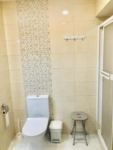a bathroom with a toilet and a stool in it at Cantinho da Glória in Aveiro