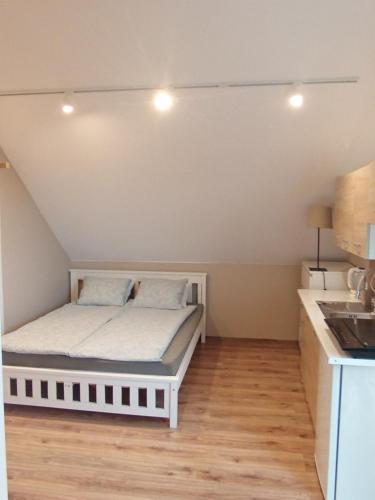 a small bedroom with a bed in a kitchen at Blisko Energylandii in Zator