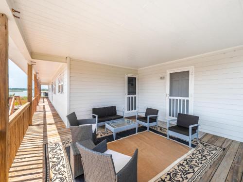 a porch with chairs and a table on a house at Sunrise in Topsail Beach