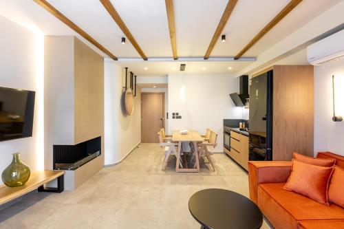 a living room with an orange couch and a table at Kave luxurystaying in Volos