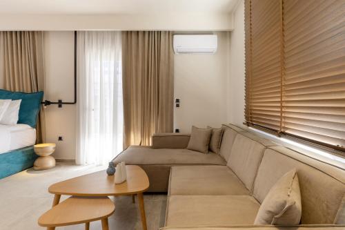 a living room with a couch and a table at Kave luxurystaying in Volos