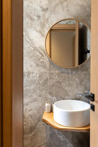 a bathroom with a white sink and a mirror at Kave luxurystaying in Volos