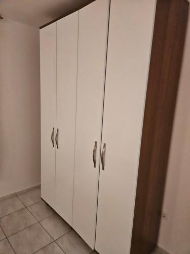 a white cabinet with silver handles in a room at Villa Amela Dubrava in Bar