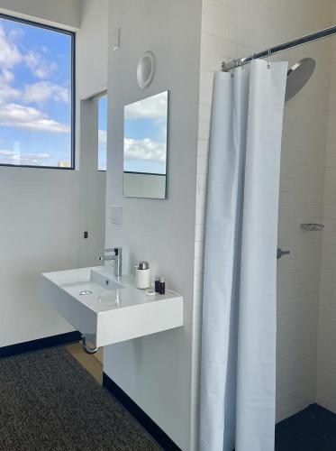 a bathroom with a sink and a shower curtain at Abpopa Hillcrest in San Diego