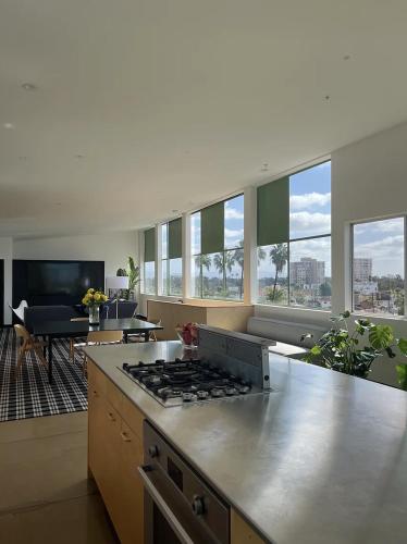 a kitchen with a stove top in a living room at Abpopa Hillcrest in San Diego
