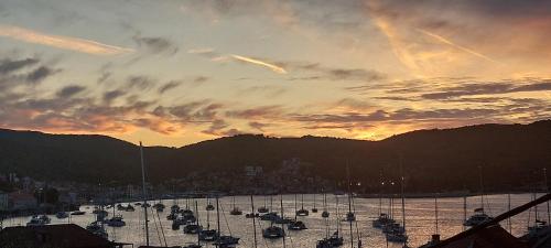 a group of boats in a harbor at sunset at Stunning view-Maleni in Vis