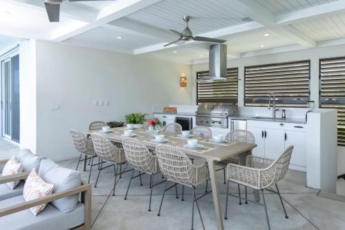 a kitchen and dining room with a table and chairs at Tropical Panorama in Cruz Bay