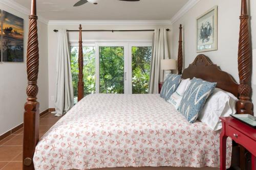 a bedroom with a bed and a window at Tropical Panorama in Cruz Bay