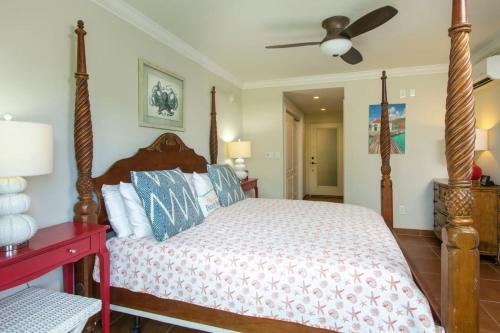 a bedroom with a bed and a ceiling fan at Tropical Panorama in Cruz Bay