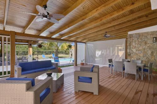 a living room with furniture and a ceiling fan at Comfy Spacious Villa W- Pool, Jacuzzi, Bbq in Juan Dolio