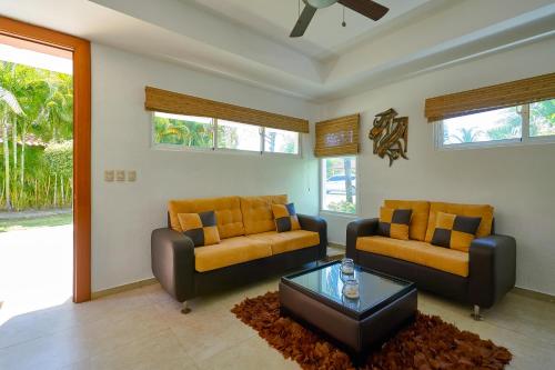a living room with two couches and a coffee table at Comfy Spacious Villa W- Pool, Jacuzzi, Bbq in Juan Dolio