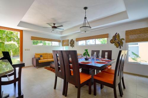 a dining room and living room with a table and chairs at Comfy Spacious Villa W- Pool, Jacuzzi, Bbq in Juan Dolio