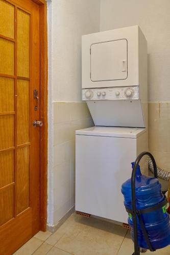 a microwave oven sitting on top of a refrigerator at Comfy Spacious Villa W- Pool, Jacuzzi, Bbq in Juan Dolio