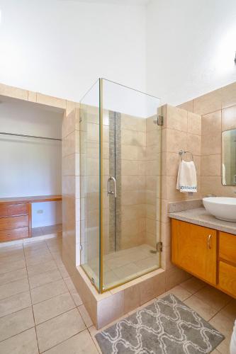 a bathroom with a shower and a sink at Comfy Spacious Villa W- Pool, Jacuzzi, Bbq in Juan Dolio