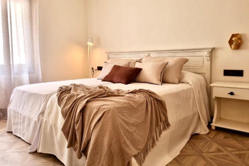 a bedroom with a large white bed with pillows at La Posada de Ruba in Biescas