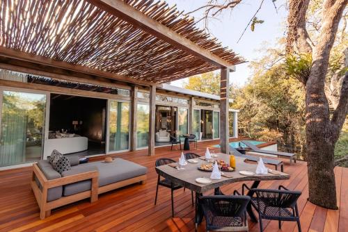 an outdoor living room with a table and chairs at Kapama Karula in Kapama Private Game Reserve