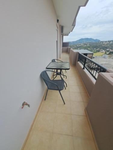 a balcony with a table and chairs on it at Angel Rooms in Yiofirákia