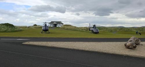 a couple of helicopters parked on the side of a road at Blue Door Apartment Main St, Carrigart, F92HC04 in Carrigart
