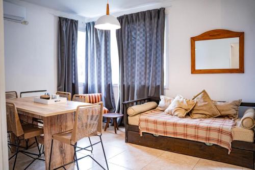 a living room with a couch and a dining room table at QHAWANA CABAÑAS & SUITES in La Rioja