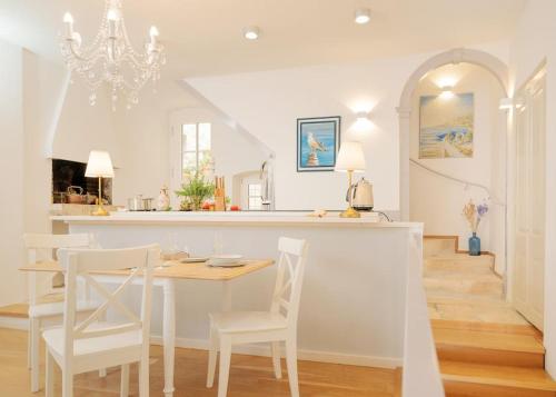 a kitchen and dining room with a table and chairs at Villa Dida Hvar in Hvar