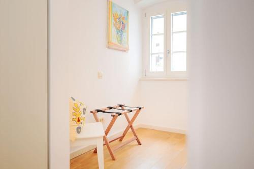 a white room with a chair and a window at Villa Dida Hvar in Hvar
