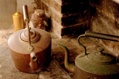 an old tea kettle and pot sitting next to a fireplace at Villa Dida Hvar in Hvar