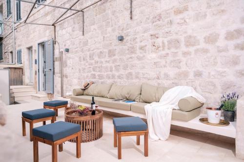 a living room with a couch and a brick wall at Villa Dida Hvar in Hvar