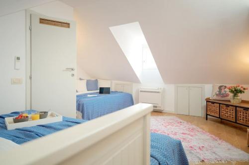 a white bedroom with a bed and a window at Villa Dida Hvar in Hvar