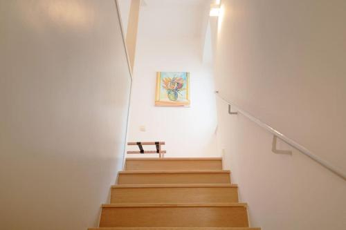 a staircase in a white room with a bench on the wall at Villa Dida Hvar in Hvar