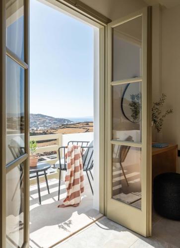 a sliding glass door with a view of a balcony at Philosophy of Mykonos Boutique Hotel in Mýkonos City