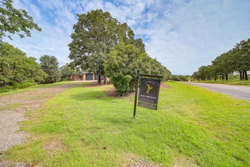 a sign in the grass next to a road at Lakefront Eufaula Vacation Rental with Private Dock in Eufaula