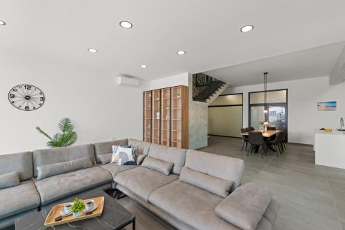 a living room with a couch and a table at Villa La Vie in Crikvenica