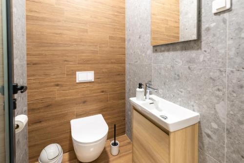a bathroom with a white sink and a toilet at Villa La Vie in Crikvenica