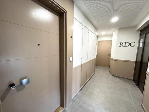 an empty hallway with a rbc sign on the wall at Cosy Apartment - Parking, Garden,10mn from Disneyland! in Montévrain