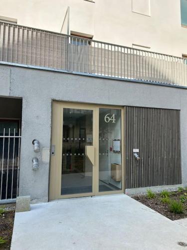 a building with a glass door in front of it at Cosy Apartment - Parking, Garden,10mn from Disneyland! in Montévrain