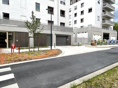 an empty street in front of a building at Cosy Apartment - Parking, Garden,10mn from Disneyland! in Montévrain