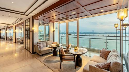 a living room with a view of the water at InterContinental Haikou Seaview by IHG in Haikou