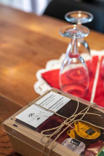 a table with a bottle of wine and a glass at Finikas Suites & Apartments Airport By Airstay in Artemida