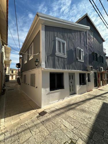 a building with a gambrel roof on a street at Dolce Vita - In the heart of Lefkada - Lefkada BnB in Lefkada Town