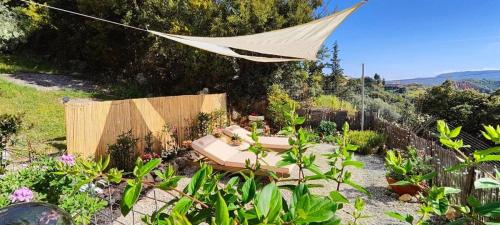 a hammock in a garden with plants at Thymes traditional house in Loúlos