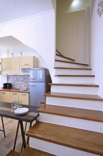 a stairway in a kitchen with a table and a kitchen at Amaryllis House Lefkada in Lefkada
