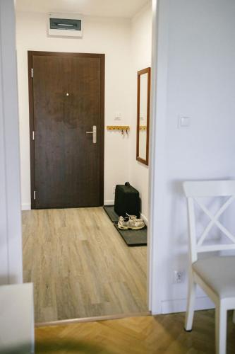 a door to a room with a suitcase on the floor at Elegantný byt v srdci Košíc in Košice