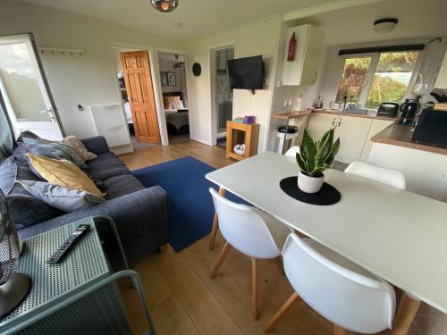 a living room with a table and a couch at 27 Sea Valley Chalet in Bucks Mills
