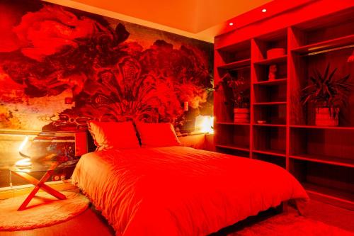 a red bedroom with a bed and a red wall at Prestige De Cocagne in Lavaur