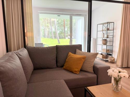 a living room with a couch and a table at Apartamenty Florina Q4Apartments in Łeba