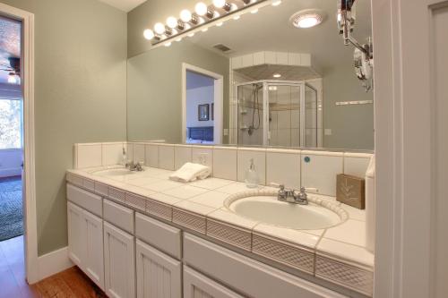 a bathroom with a sink and a large mirror at NEW! Yosemite Mountain villa, stunning views -more in Oakhurst