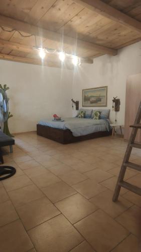 a bedroom with a bed in the middle of a room at Amélie House in Marsala