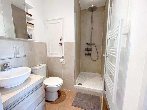 une salle de bain avec un lavabo, des toilettes et une douche dans l'établissement Cannes banane, T2 centre ville, 400 m des plages, à Cannes