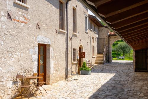 an alley in a stone building with a wooden door at Premignaga Natural Home in Gardone Riviera
